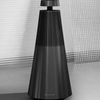 Bang & Olufsen Beosound 2 3rd Gen wireless speaker, sleek cylindrical design with fabric cover and control buttons visible.