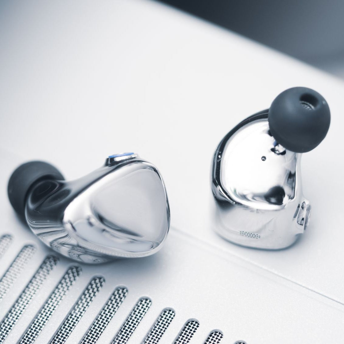 FiiO FX17 in-ear headphones with black ear tips and silver accents, shown from a front angle, highlighting their sleek design.