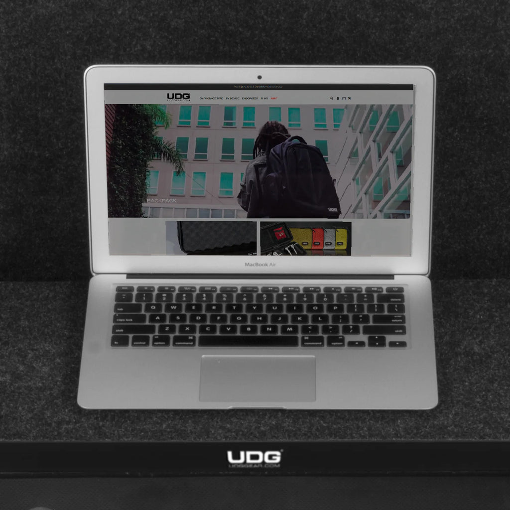UDG Ultimate Flight Case AlphaTheta DDJ-GRV6 black DJ flight case with laptop shelf, durable protective design for DJ equipment.