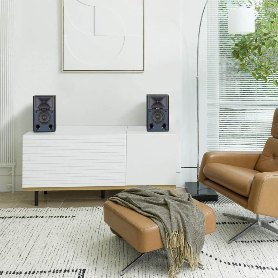 JBL 4305P active bookshelf speakers showing sleek black cabinets and detailed front grille with control knobs