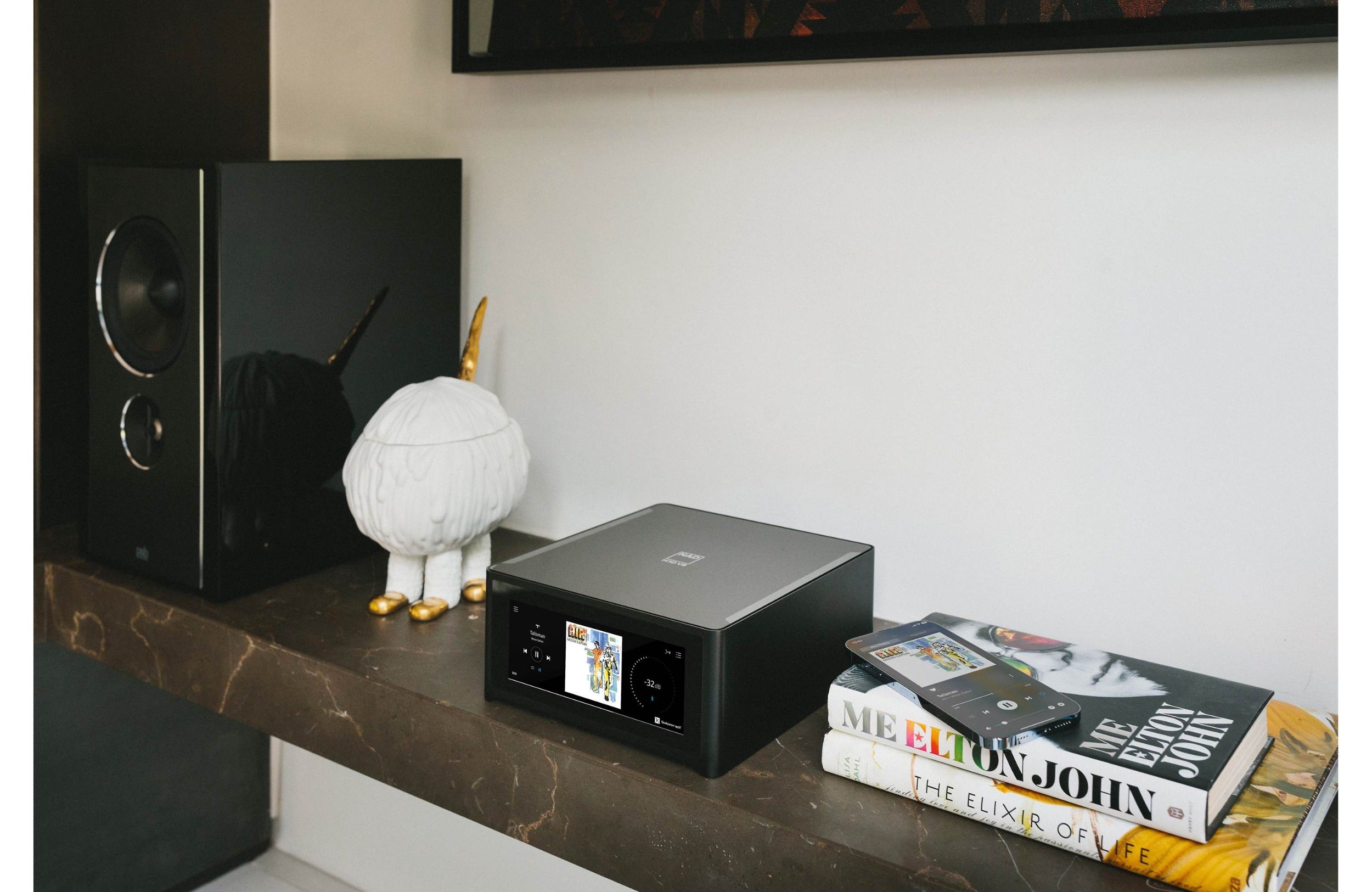 NAD M10 V3 stereo amplifier with sleek design and control knobs, showcasing its modern audio equipment features.
