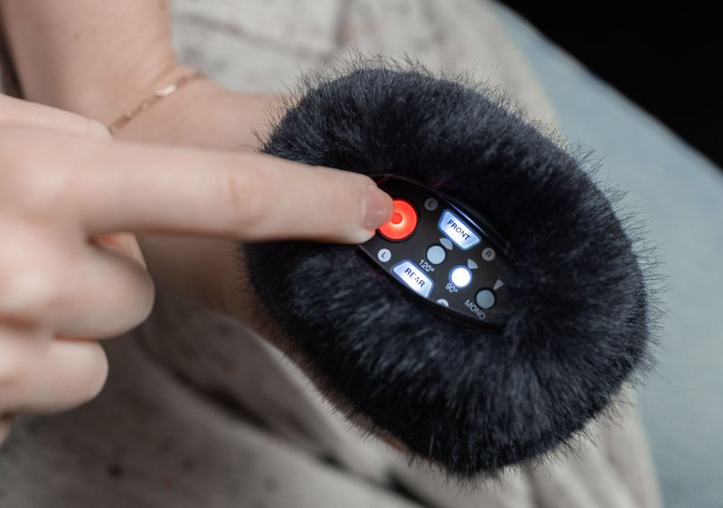 Zoom APH-2e digital recorder with windscreen inset, compact design, and built-in microphones for high-quality audio recording.