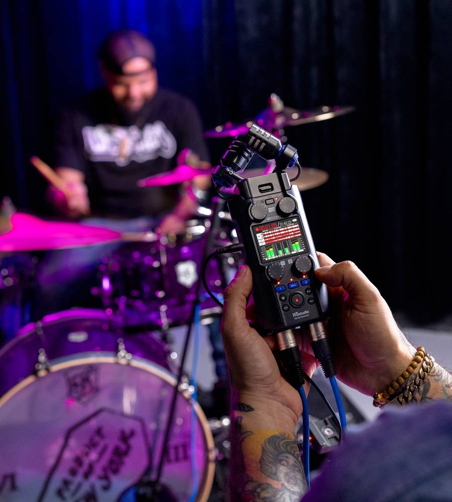 Zoom H5 digital recorder with advanced limiters, featuring professional audio controls and a compact design for high-quality recording.