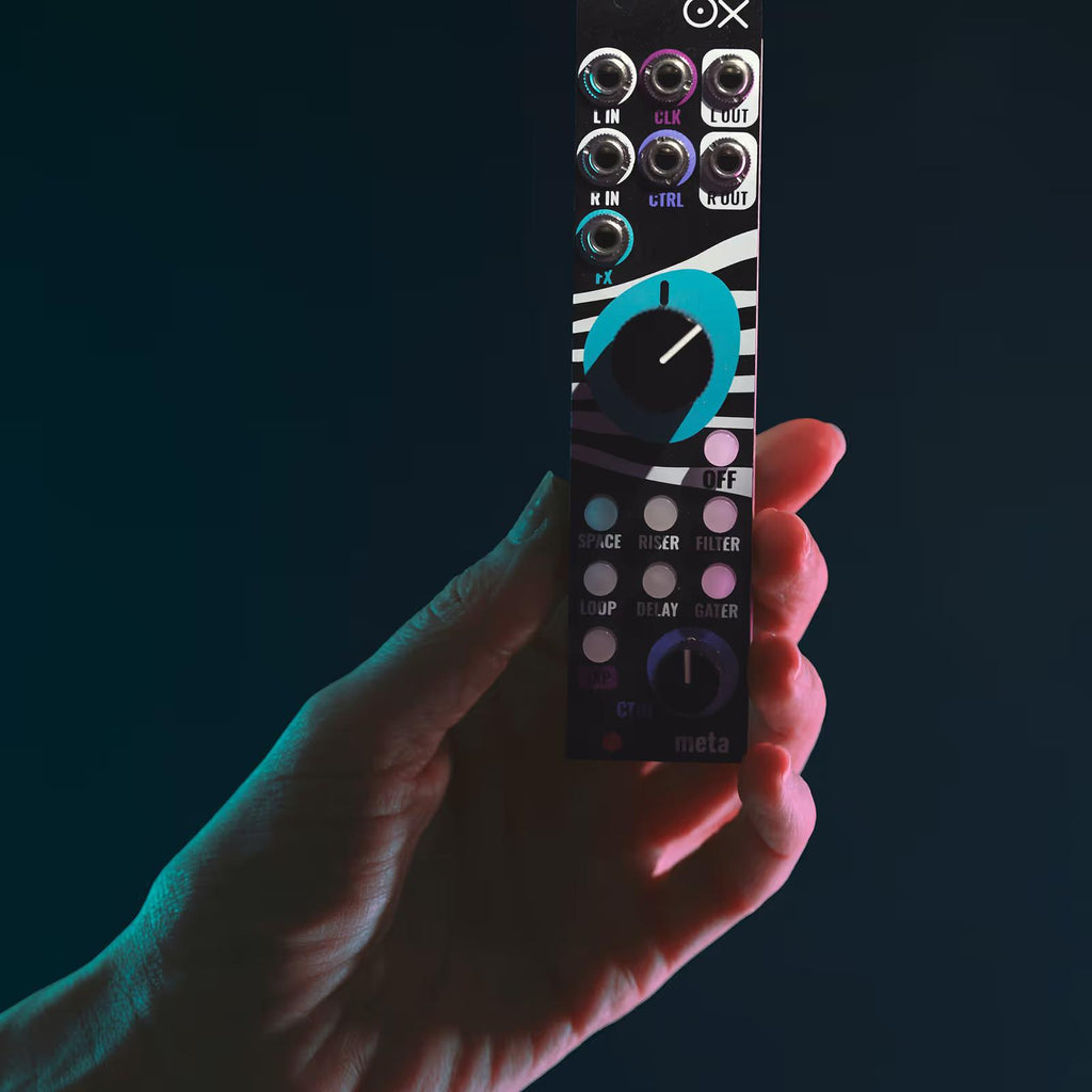 Close-up of a hand adjusting controls on the OXI Instruments Meta semi-modular synthesizer.