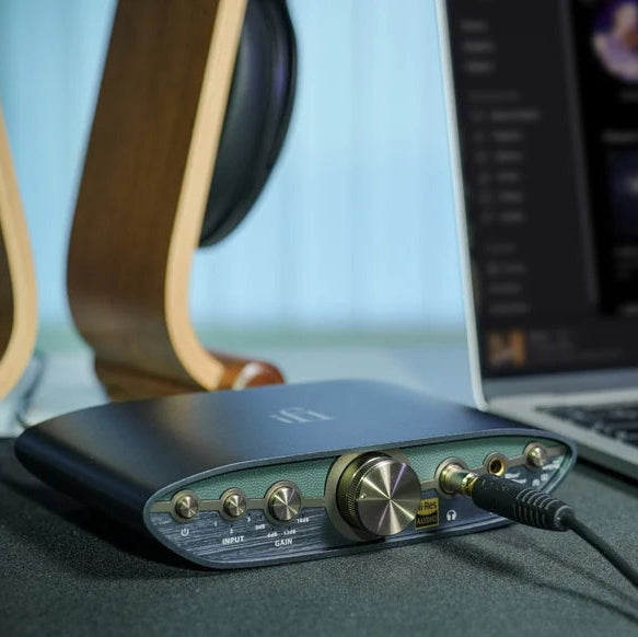 iFi Audio Zen Can 3 headphone amp / DAC, lifestyle on desk with headphones