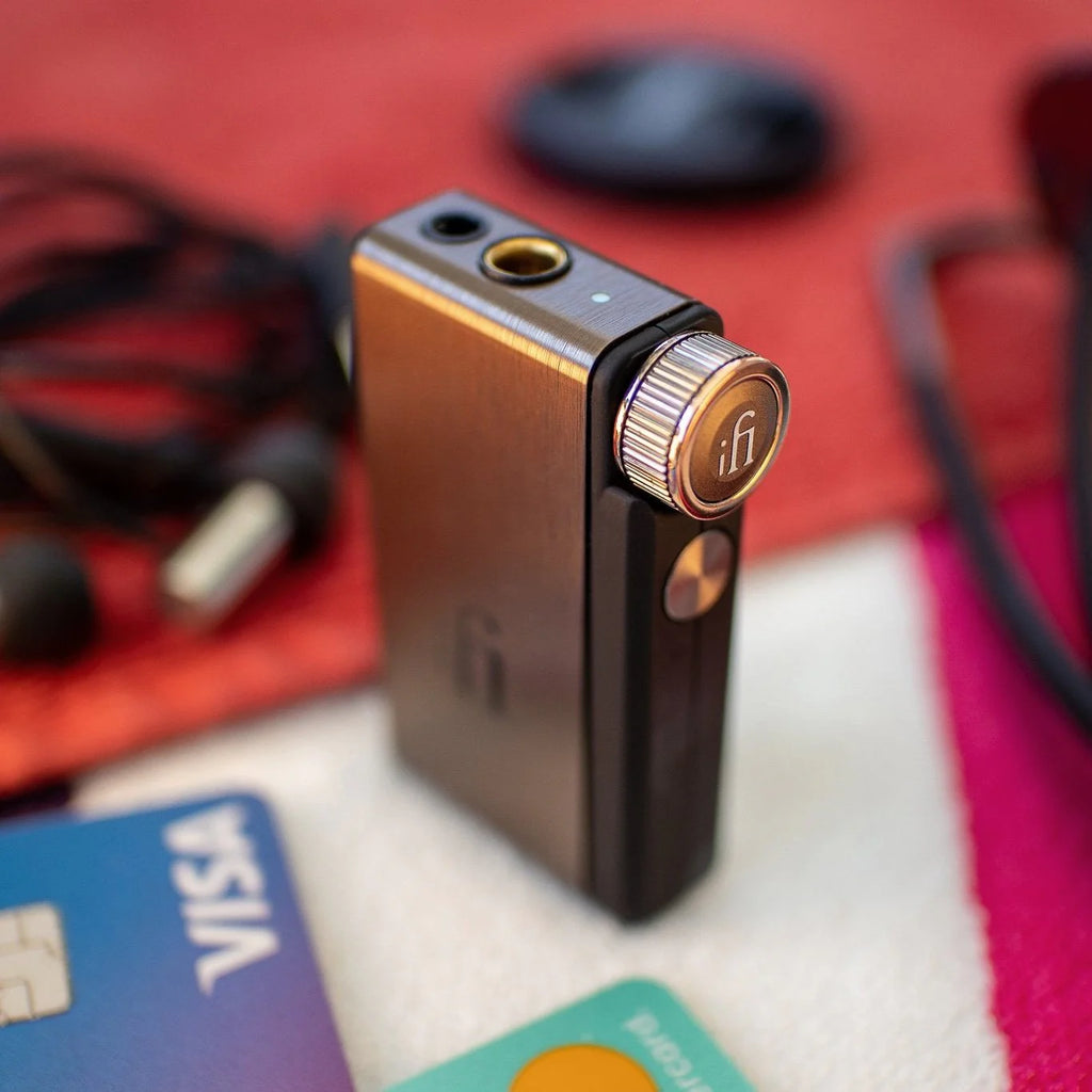 iFi Audio Go BLU headphone amplifier and DAC with compact design, black color, and various input and output ports visible.