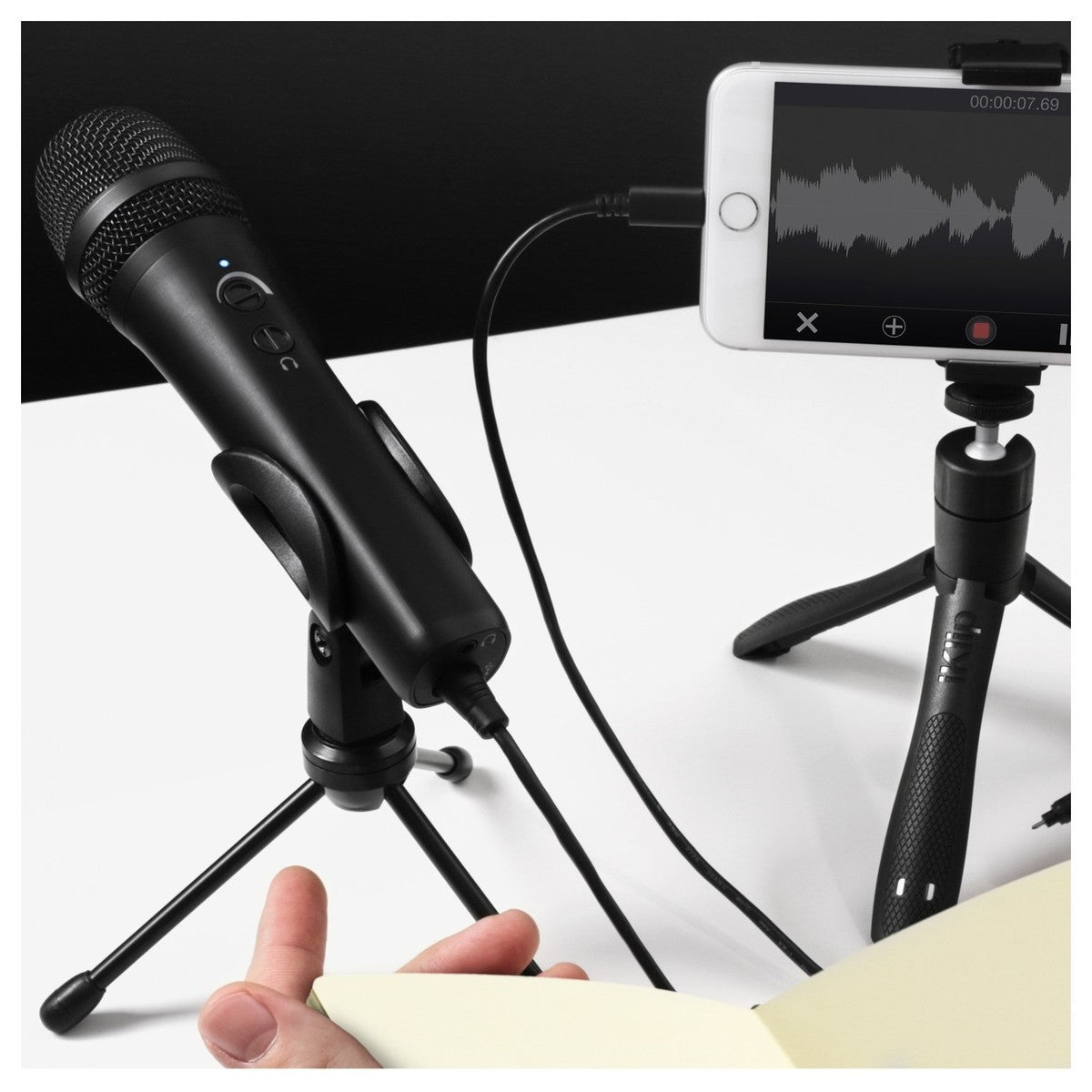 IK Multimedia iRig Mic HD 2 portable microphone for iOS and Android devices, shown connected to a smartphone.