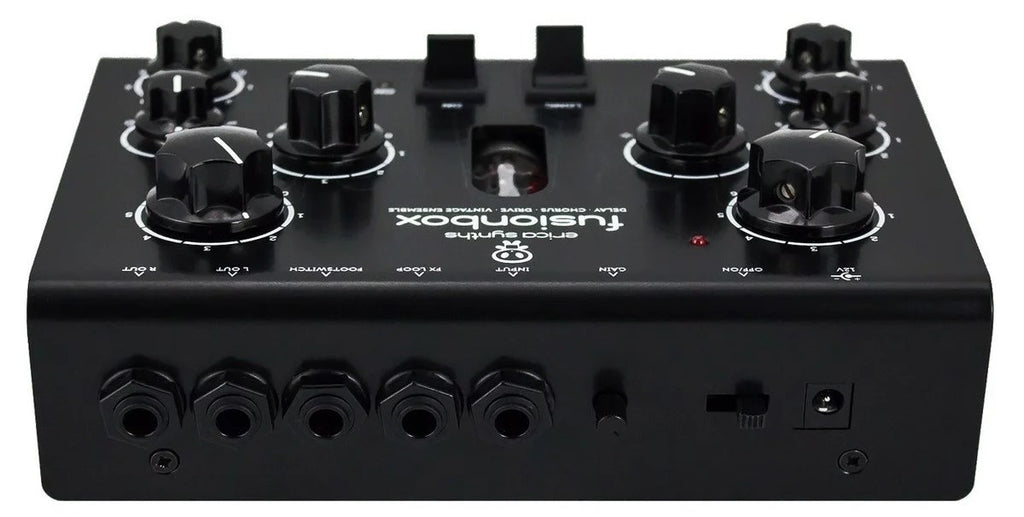 Erica Synths Acidbox III effects pedal with control knobs and input/output jacks, used for acid-style bass and synth sounds.