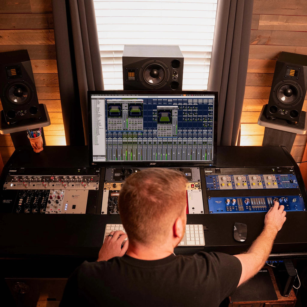 Focusrite ISA C8X USB audio interface with multiple input and output ports, shown on a desk setup with cables.