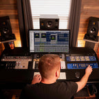 Focusrite ISA C8X USB audio interface with multiple input and output ports, shown on a desk setup with cables.