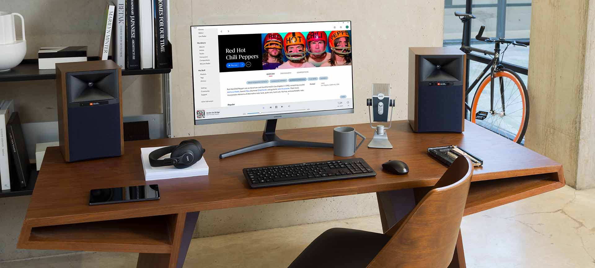 JBL 4305P active bookshelf speakers with black enclosures and silver speaker cones, positioned upright on a flat surface.