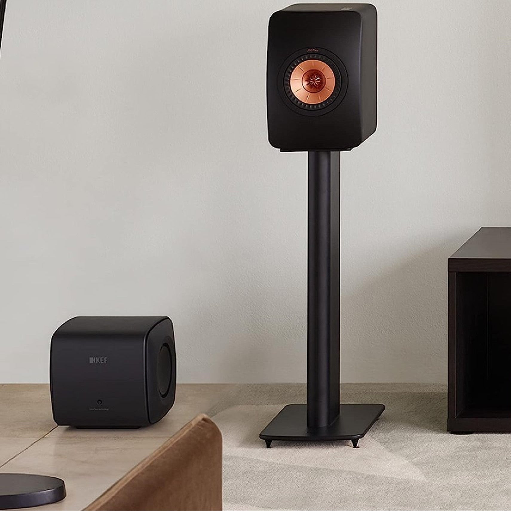 KEF KC62 subwoofer with sleek black enclosure and compact design, ideal for enhancing bass in home audio systems.
