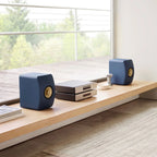 KEF LS50 Meta passive bookshelf speakers with sleek blue finish and modern design, showcasing high-quality audio equipment.