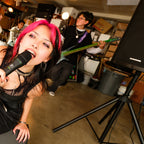 Band rehearsing in a garage with a Mackie Thrashv2 loudspeaker pole-mounted on a stand