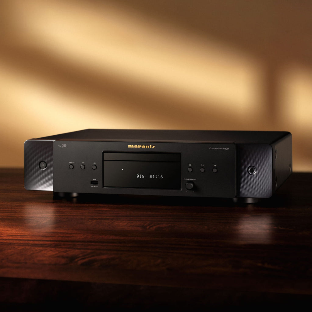 Marantz CD 70 Black on a wooden console in a warmly lit living room