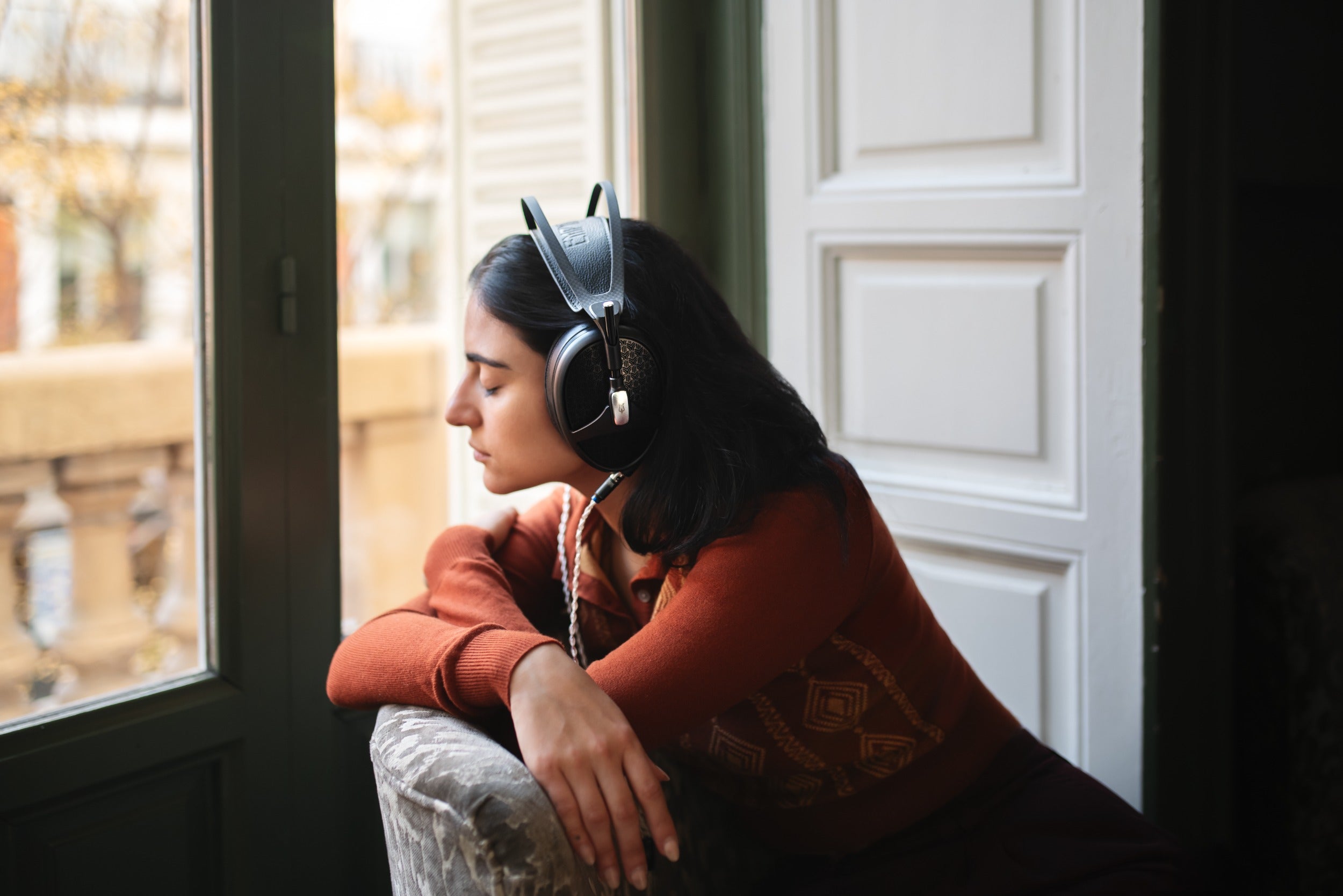 Wired Meze Audio Empyrean II headphones with large ear cups and plush ear cushions, showing their sleek design and premium build.