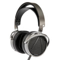 Audeze MM-100 studio headphones with large over-ear design, black ear cups, and adjustable headband for professional audio mixing.