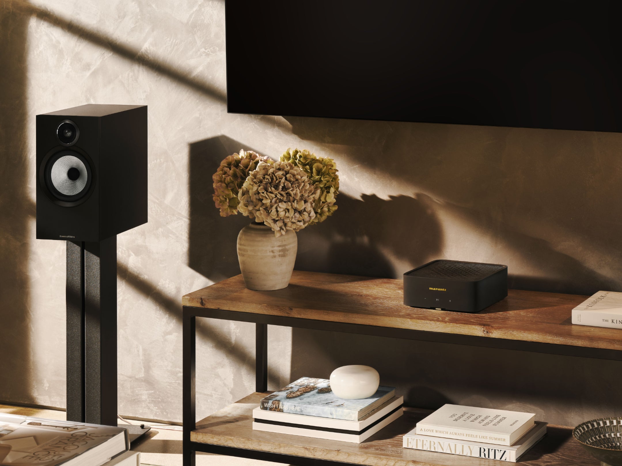 Marantz MODEL M1 music streamer connected to TV, showcasing sleek design and high-quality soundbar performance.