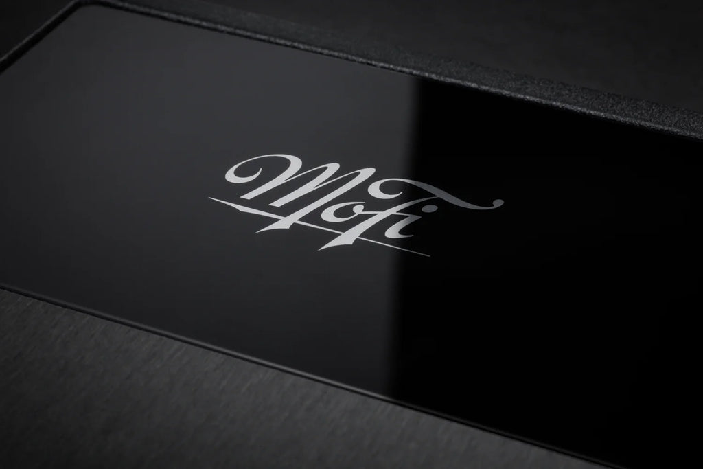 Close-up of MoFi Electronics UltraPhono phono preamp showing input and control knobs on a sleek black device.