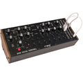 Moog DFAM analog synthesizer with patch cables and control knobs, showcasing its modular drum synthesizer design.