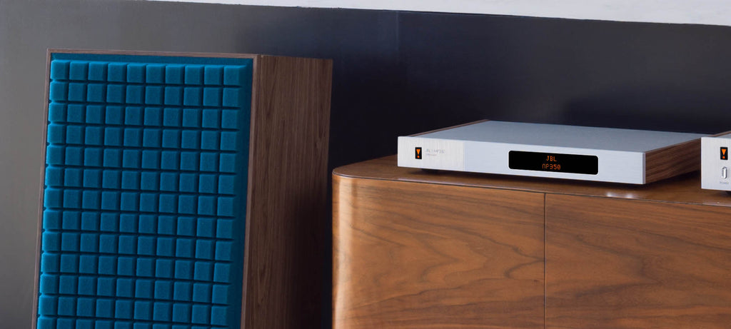 JBL MP350 Classic music streamer connected to a desktop computer, showing its sleek design and user interface on the screen.