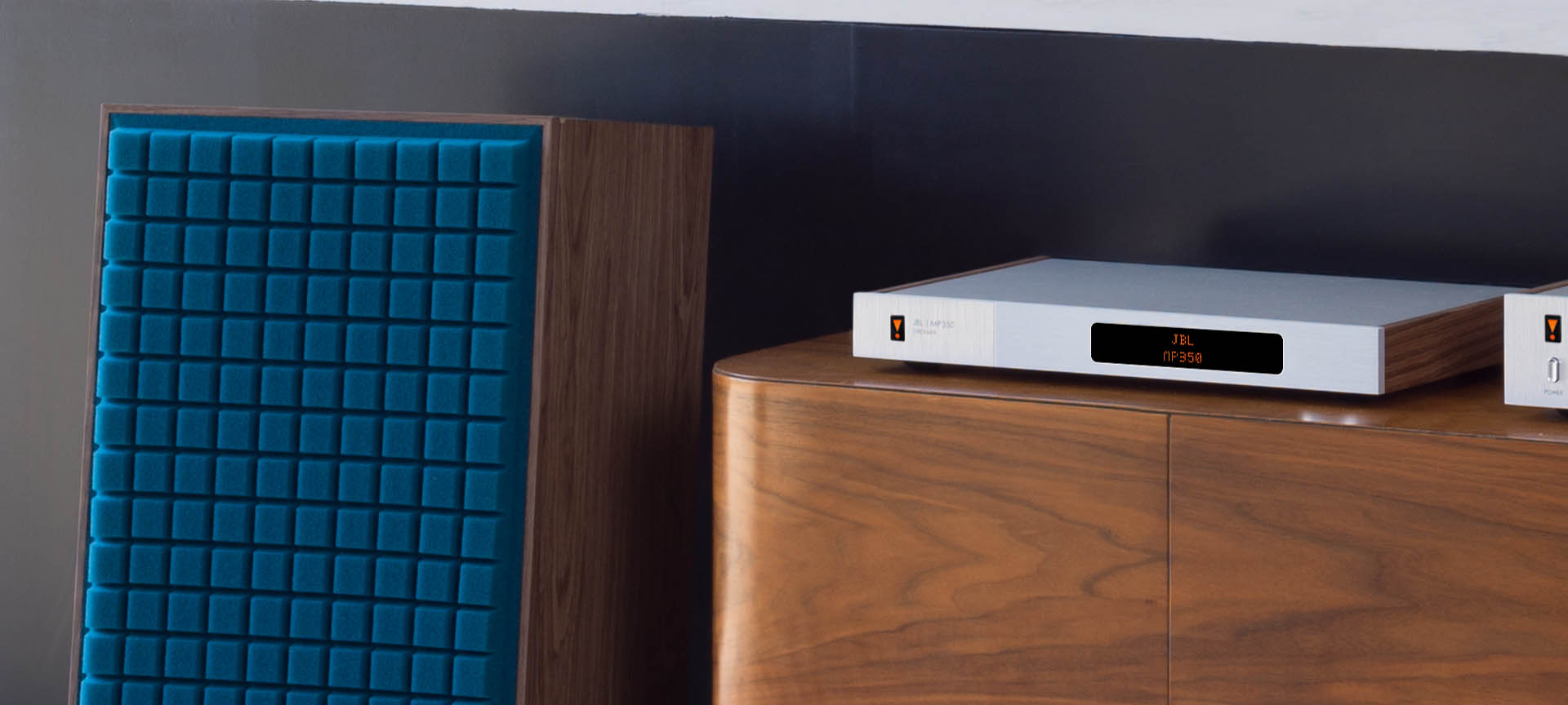 JBL MP350 Classic music streamer connected to a desktop computer, showing its sleek design and user interface on the screen.