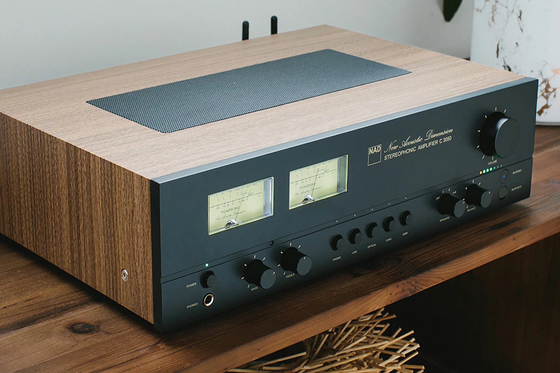 NAD C 3050 stereo amplifier shown from an angled view, showcasing its sleek design and control knobs for high-quality audio.