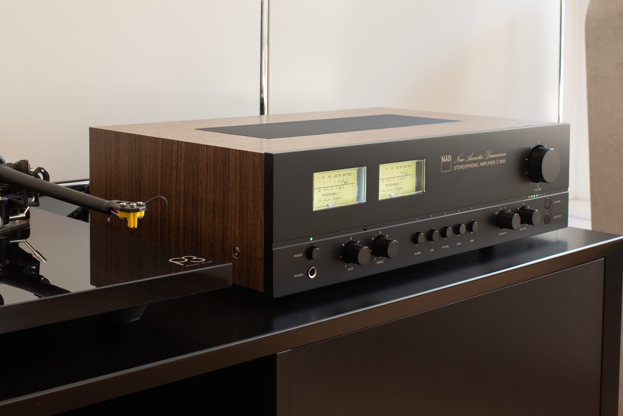 NAD C 3050 stereo amplifier with sleek black design and control knobs, showcasing high-quality audio equipment for home sound systems.