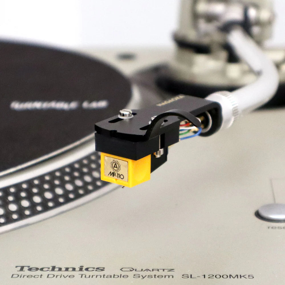 Nagaoka MP-110H turntable cartridge with headshell, featuring a sleek design and stylus for high-quality vinyl playback.