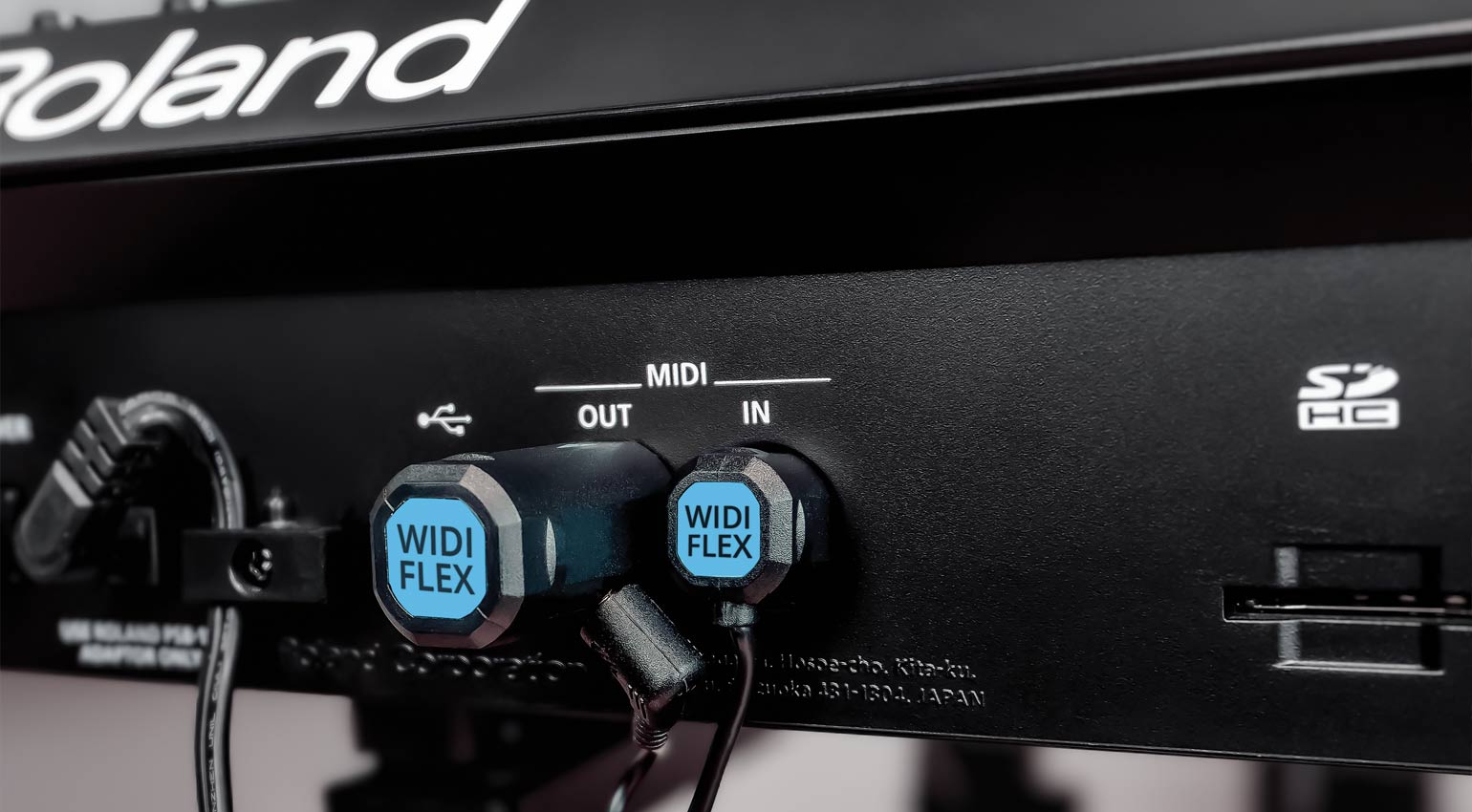 Nektar Widiflex wireless MIDI cable connecting musical keyboard to audio interface via Bluetooth, compact and modern design.