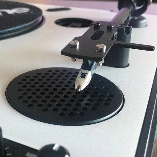 Ortofon OM Q.Bert turntable cartridge mounted on a turntable, featuring black body and stylus for high-quality vinyl playback.