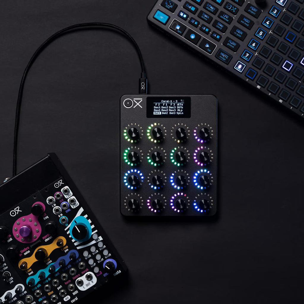 OXI Instruments E16 MIDI controller with multiple knobs and pads, shown in a group shot of OXI Instruments MIDI controllers.