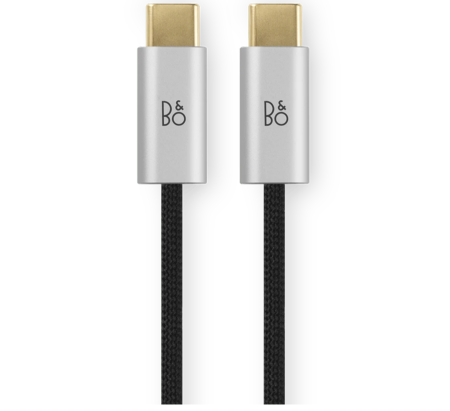 Bang & Olufsen Beoplay H100 wireless headphones with black fabric cable, shown in packshot with close-up detail.