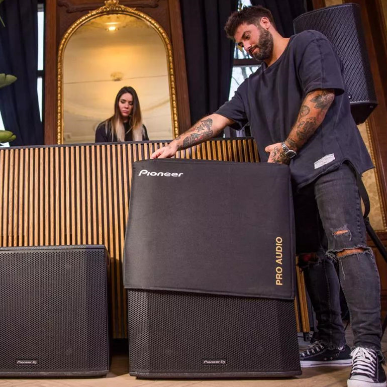 Pioneer DJ XPRS 1182S active subwoofer showing its black enclosure and front grille with control panel and speaker components visible.