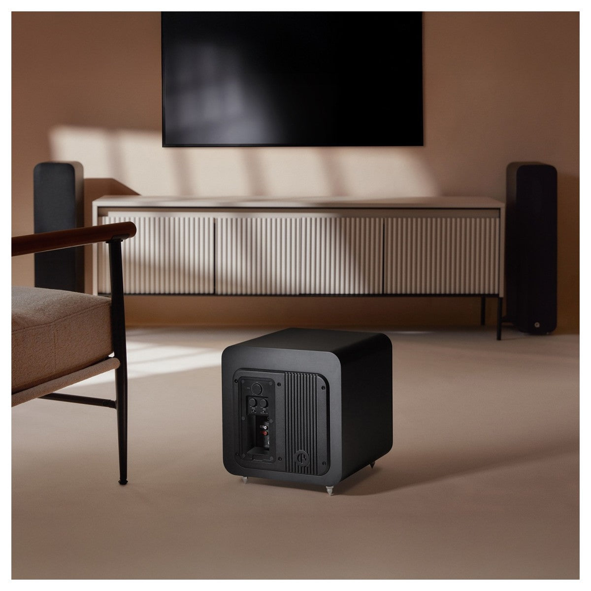 Q Acoustics Q SUB80 subwoofer with a sleek black cabinet and front grille, designed for deep bass in home audio systems.