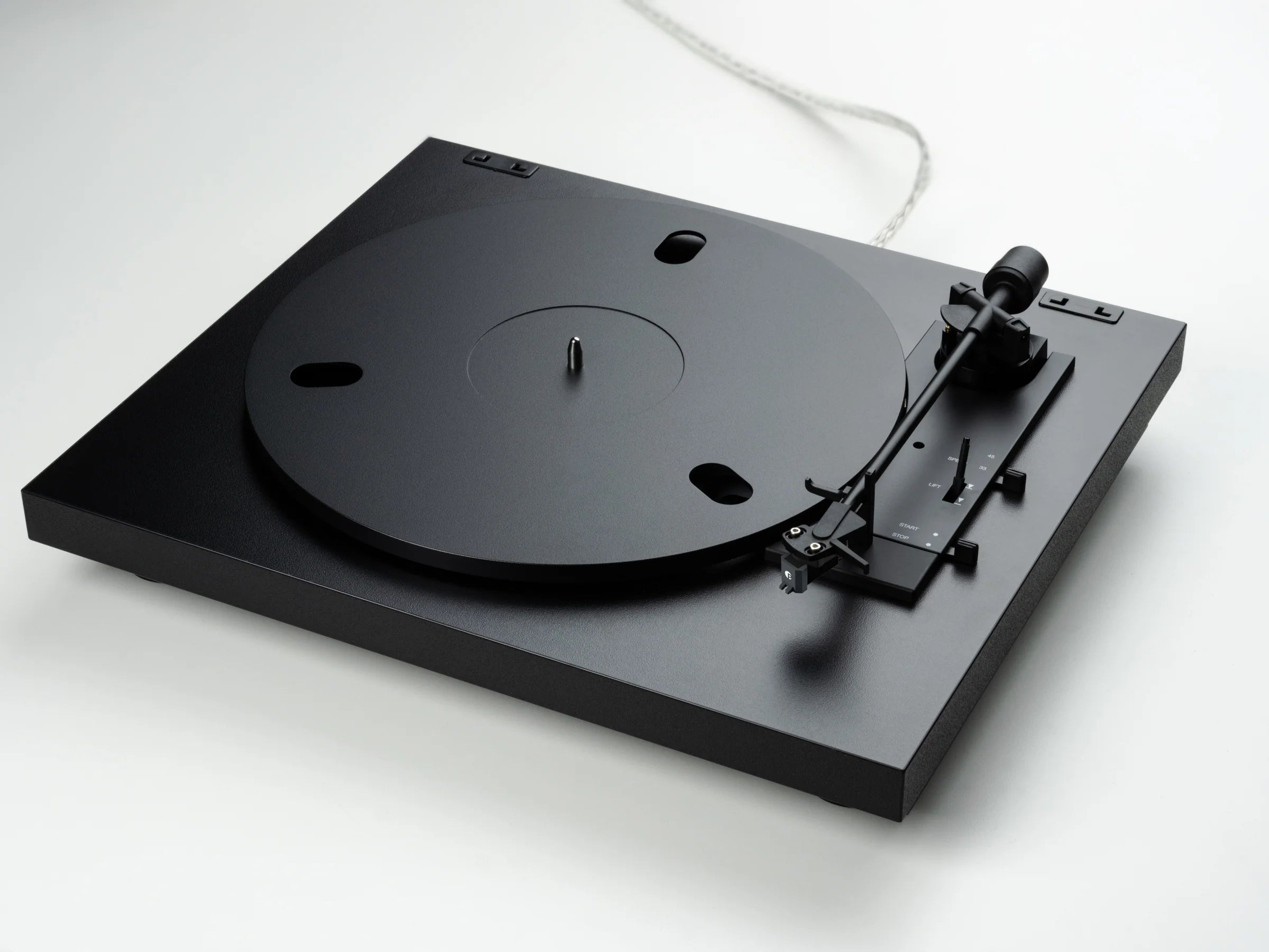 Pro-Ject Automat A1.2 turntable in black, featuring a sleek design with a tonearm and platter visible from a diagonal angle.