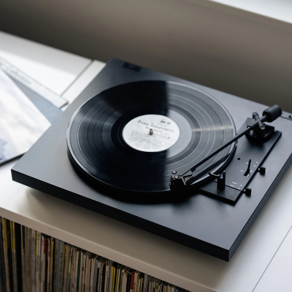 Pro-Ject Automat A1.2 turntable with sleek design, featuring a tonearm and platter, ideal for high-quality vinyl listening.