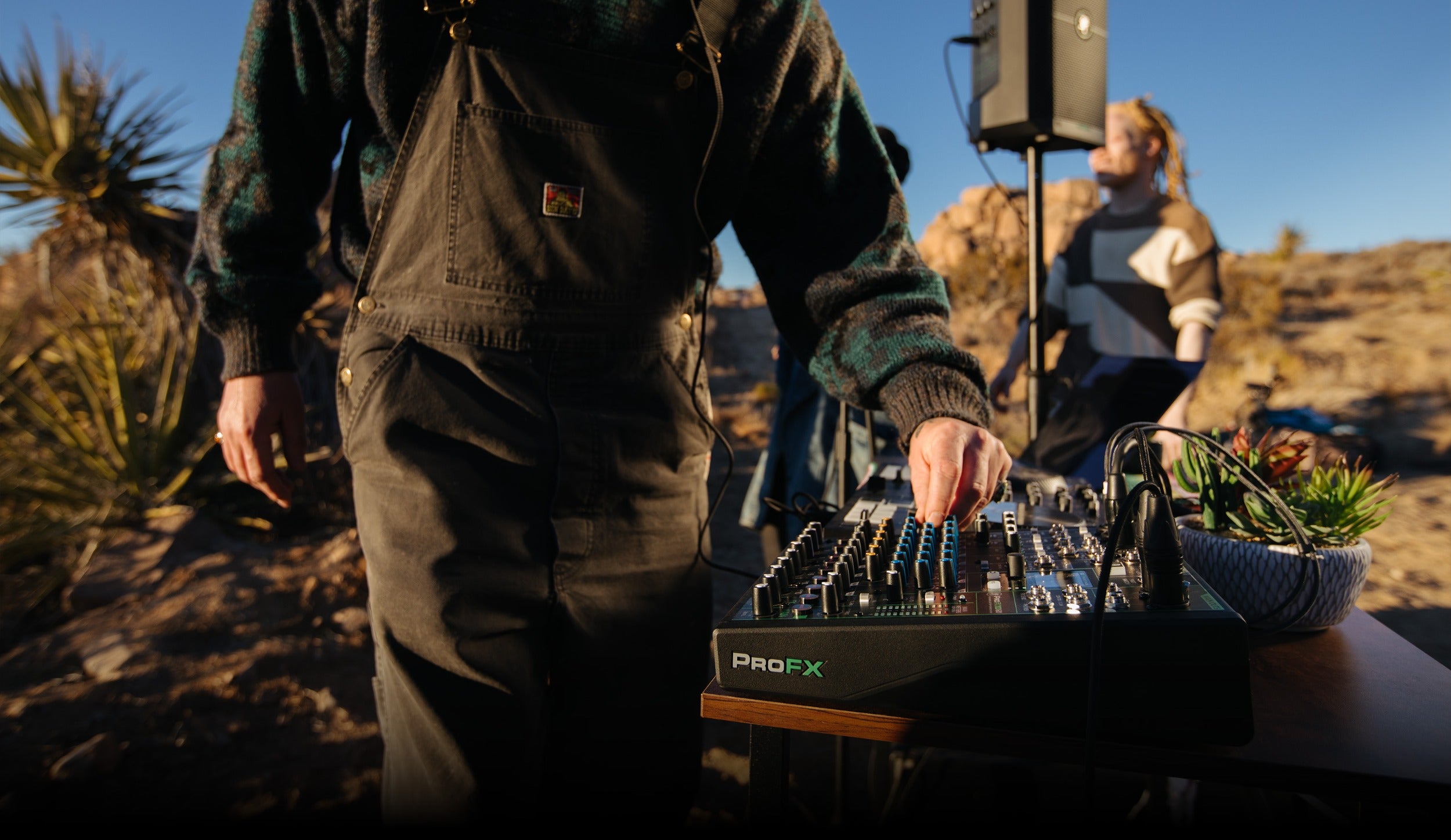 Mackie ProFX10 GO analog mixer with multiple input channels, knobs, and connection ports on a desktop surface.
