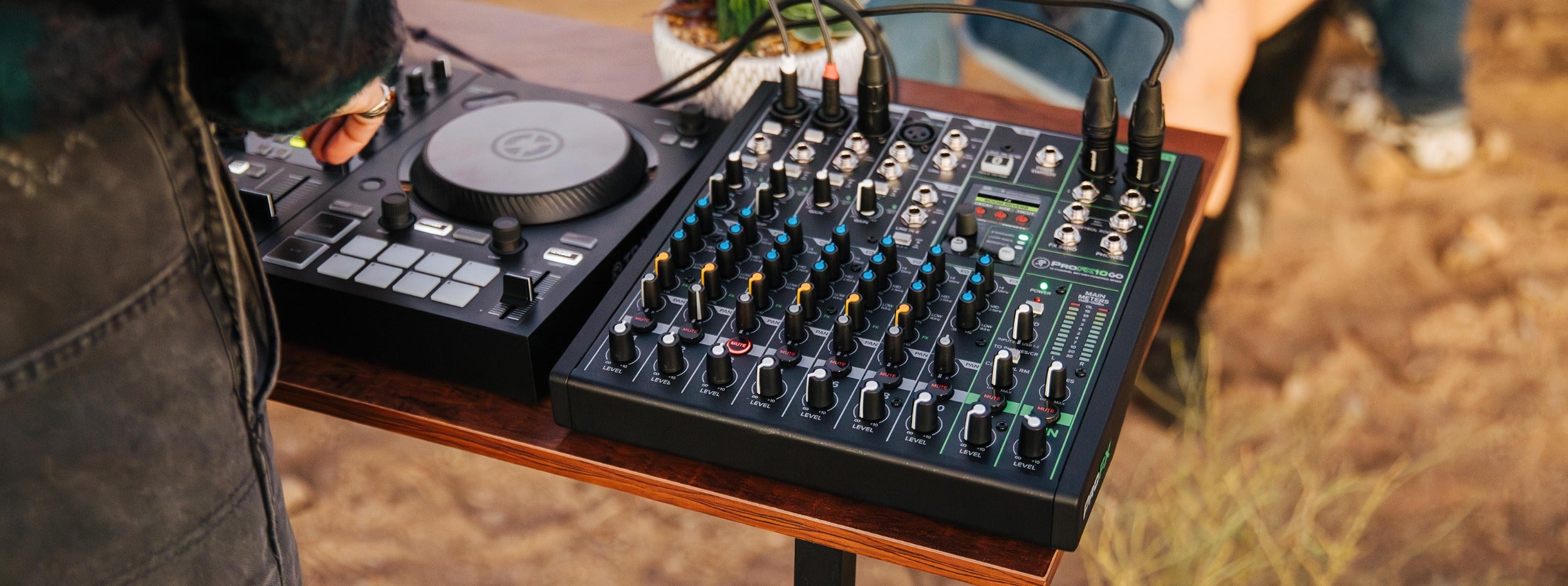 Mackie ProFX10 GO analog mixer with multiple input channels, knobs, and faders on a clean desktop setup.
