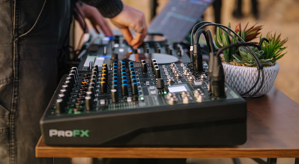 Mackie ProFX10 GO analog mixer with multiple input channels, knobs, and audio controls, shown in a detailed close-up image.