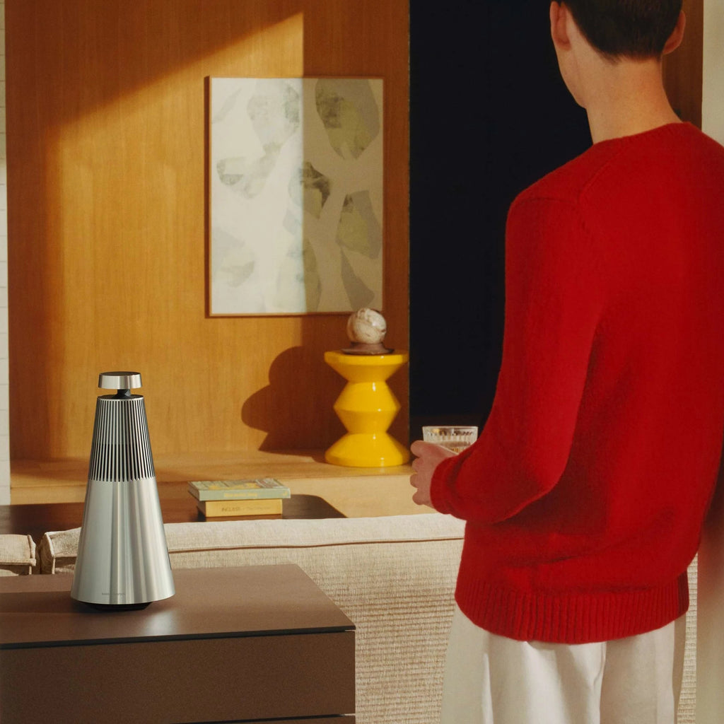 Red Bang & Olufsen Beosound 2 3rd Gen wireless speaker with sleek cylindrical design and premium finish.