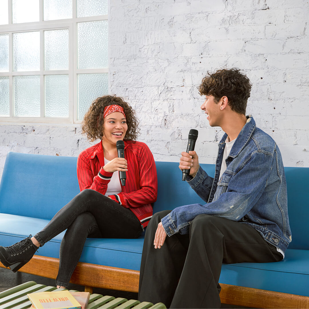 Wireless microphone accessory from Rode, shown attached to a couch for interview setup, with a close-up of the Rode Interview Pro.