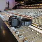 sE Electronics KLS 150 headphones resting on a large-format mixing console