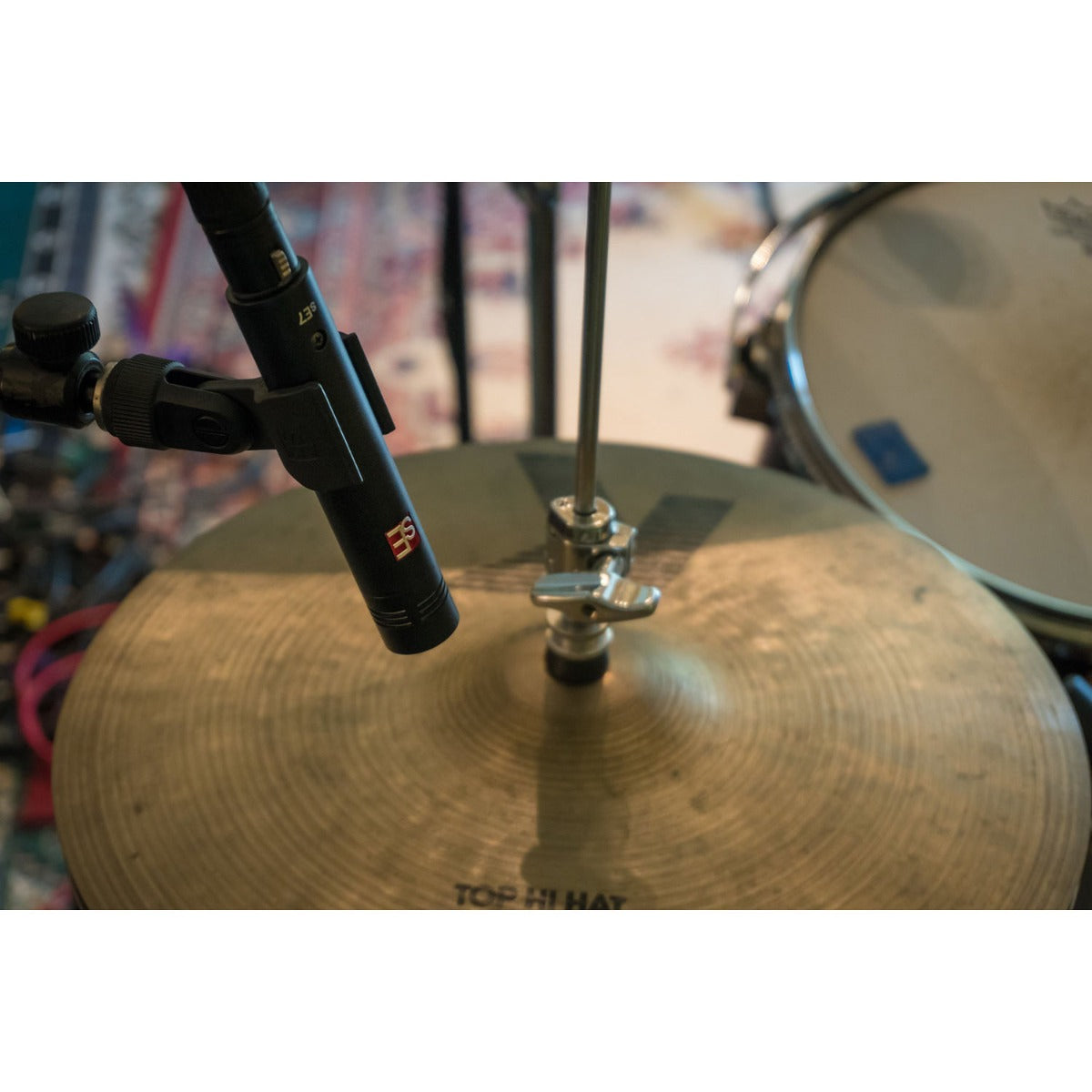 sE Electronics sE7 condenser microphone shown on a stand, with a black body and metal grille, ideal for studio recording.