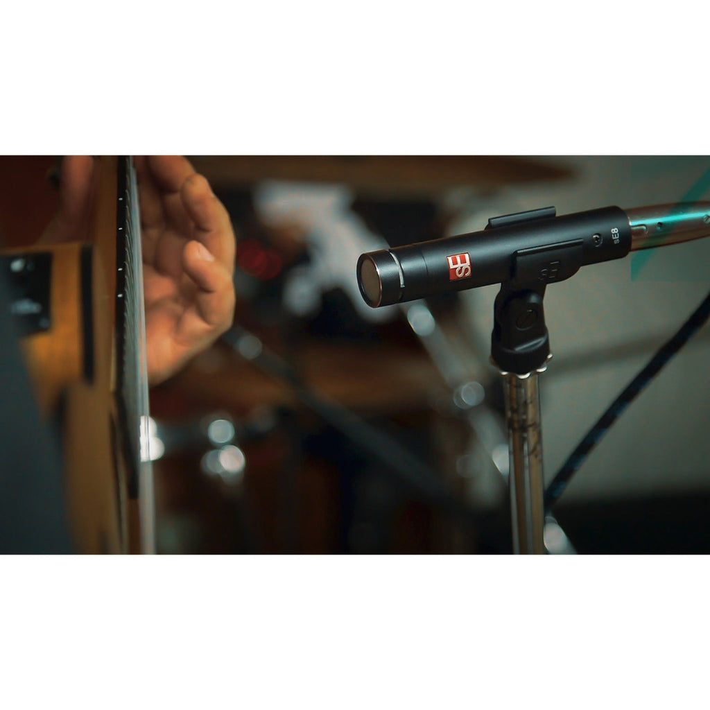Pair of sE Electronics sE8 condenser microphones shown in stereo setup, featuring black bodies and gold-plated capsules.