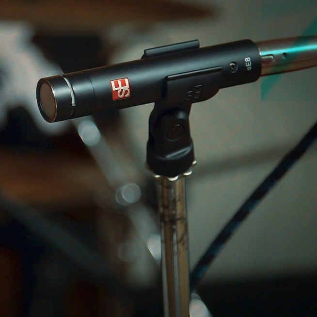 Pair of SE Electronics sE8 stereo condenser microphones set up for recording, showcasing the sleek black microphone bodies.