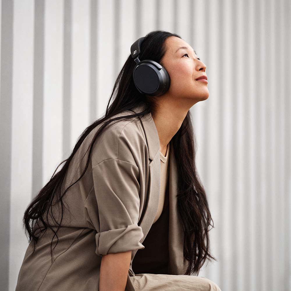Sennheiser Momentum 4 Wireless headphones, lifestyle worn by a woman, black
