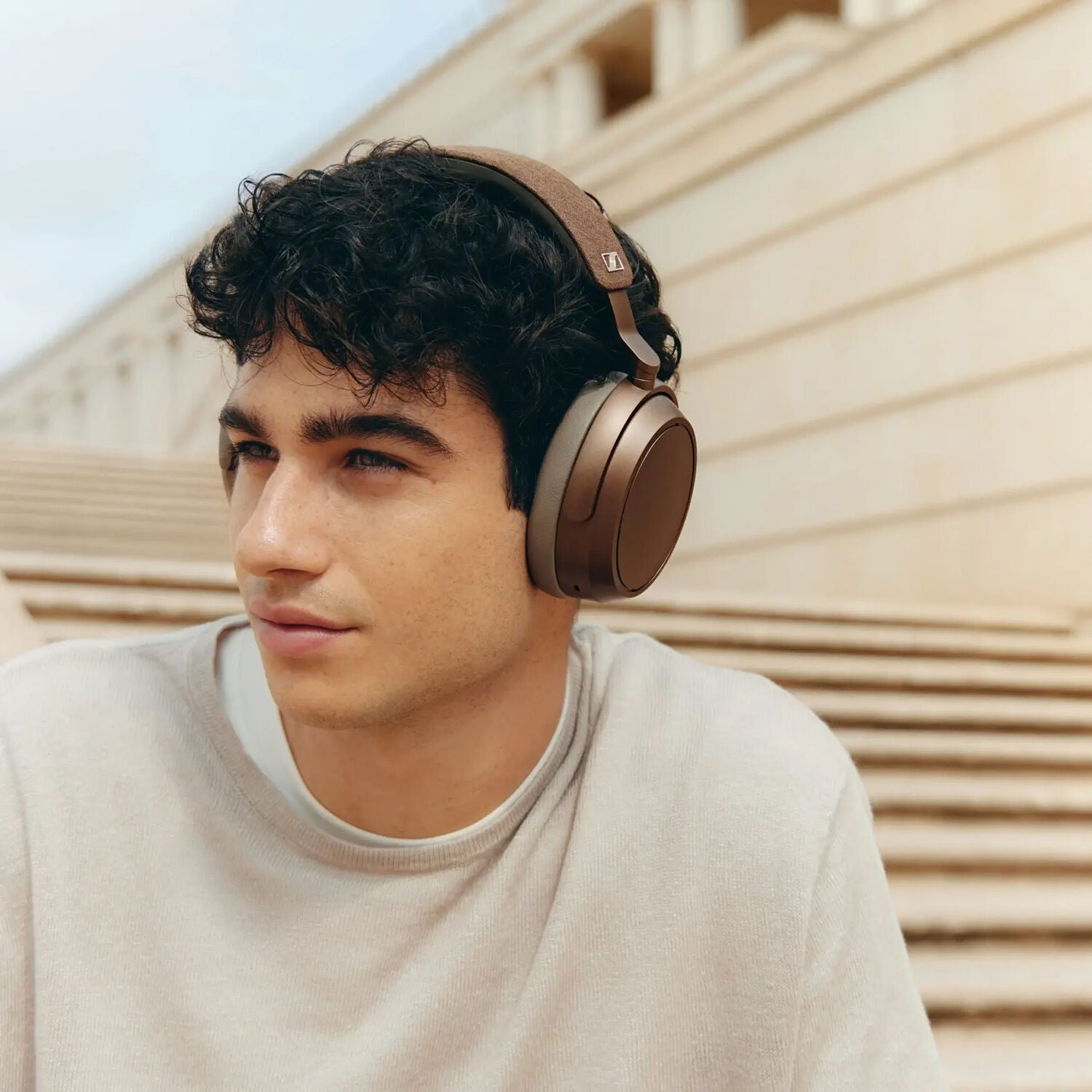 Sennheiser Momentum 4 Wireless headphones, lifestyle worn by a man, copper