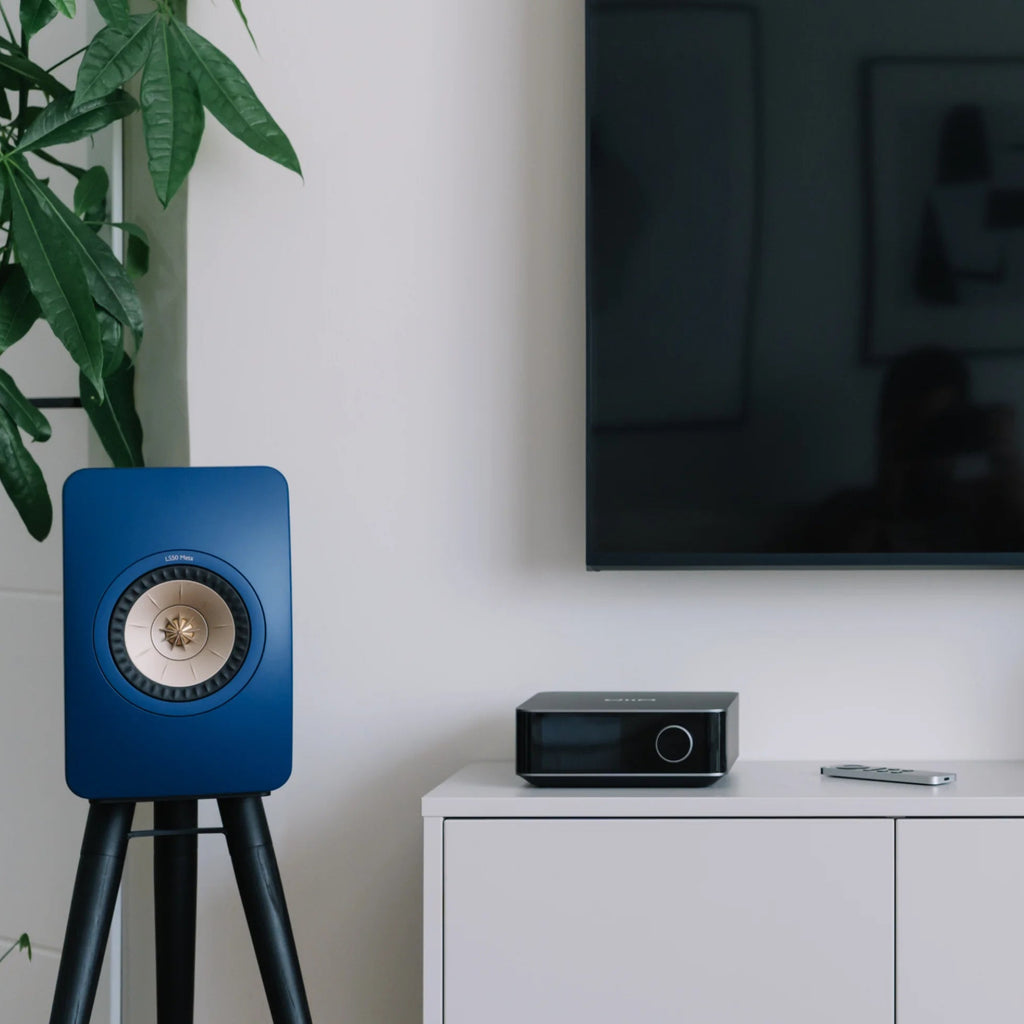 WiiM Amp Ultra stereo amplifier with sleek design and control knobs, showcasing high-quality audio equipment for enhanced sound.