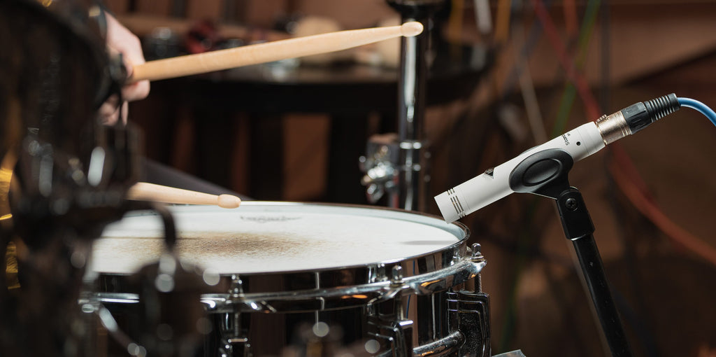 Universal Audio SP-1 condenser microphone shown with detailed metallic body and grille, ideal for professional audio recording.